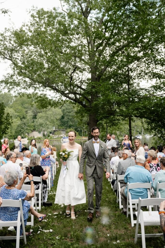 bride and groom walking down the aisle outdoor wedding venue decor